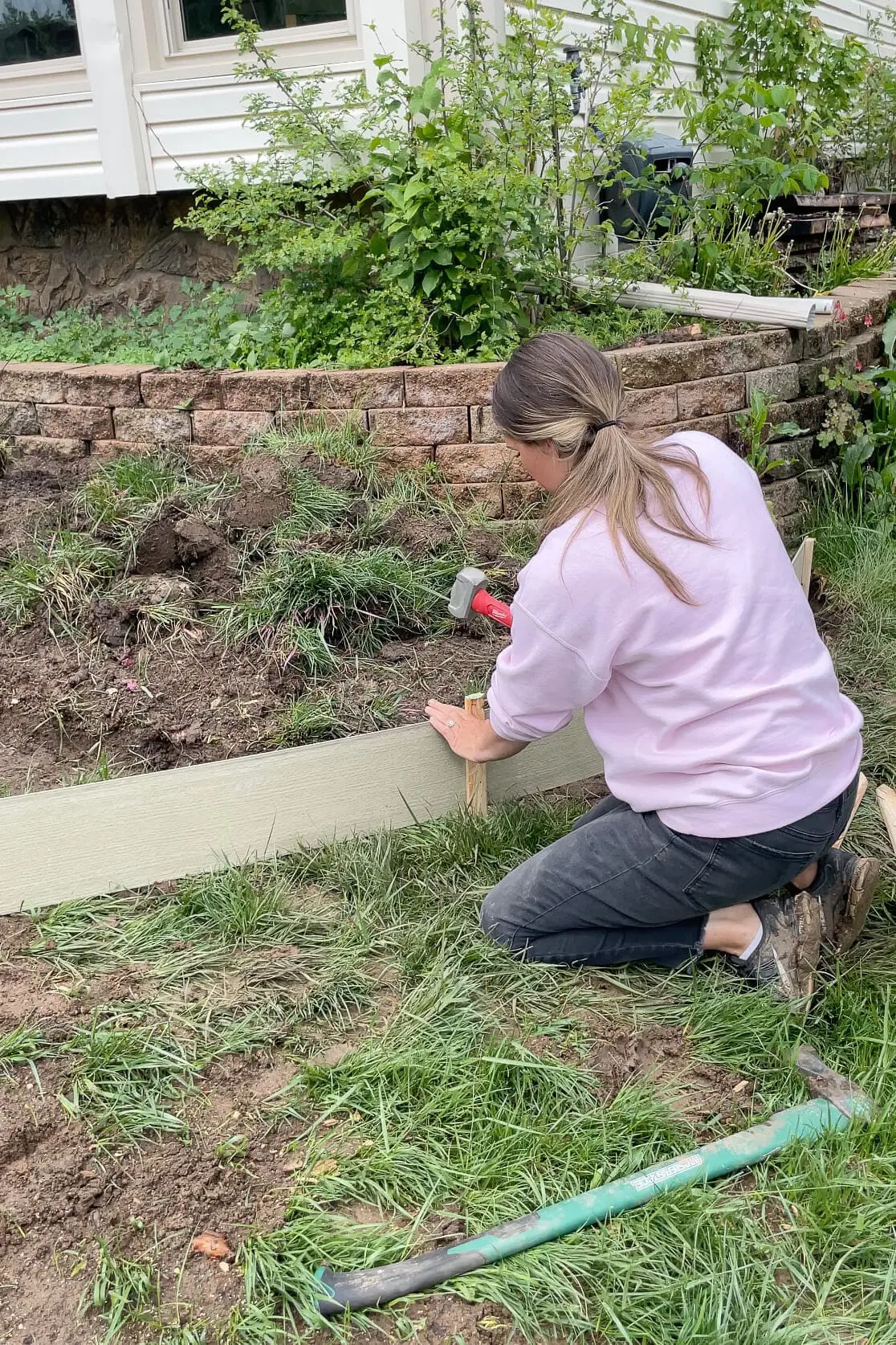 Putting up forms for pouring a concrete curb.